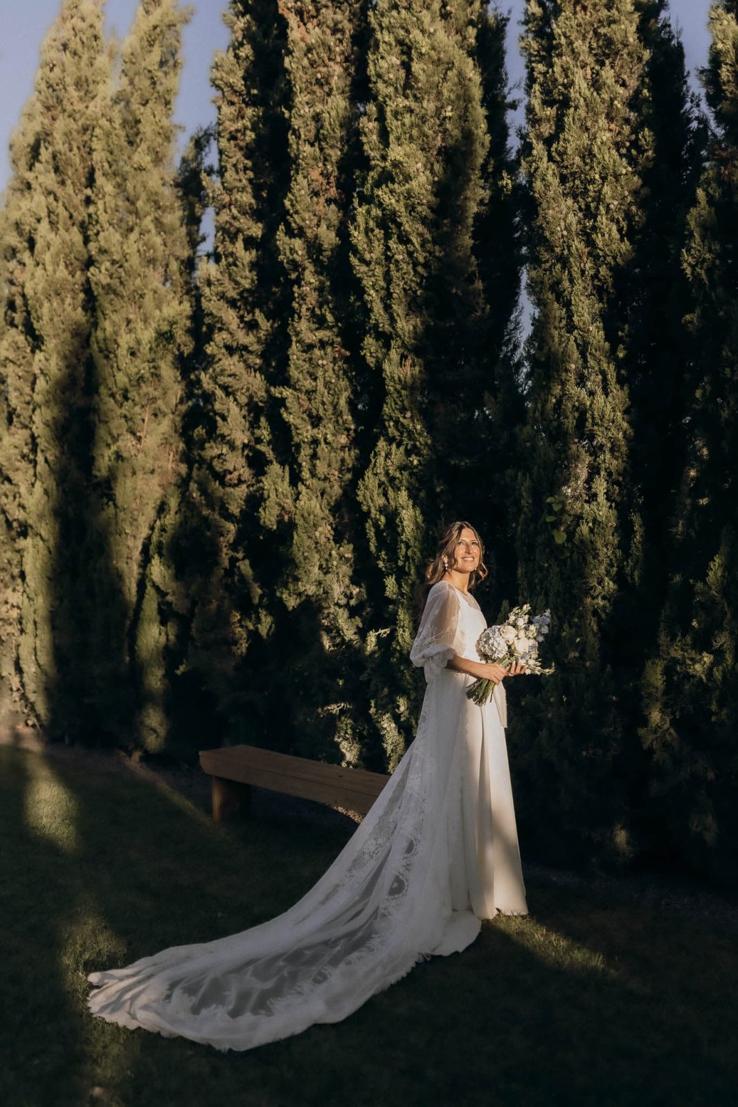 bride wearing wedding dress with detachable lace cape